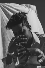 Stylish black and white photo of a customer browsing jewelry on a smartphone.