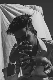 Stylish black and white photo of a customer browsing jewelry on a smartphone.