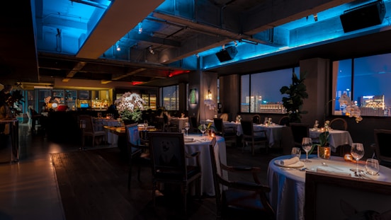 a dimly lit restaurant with a view of the city
