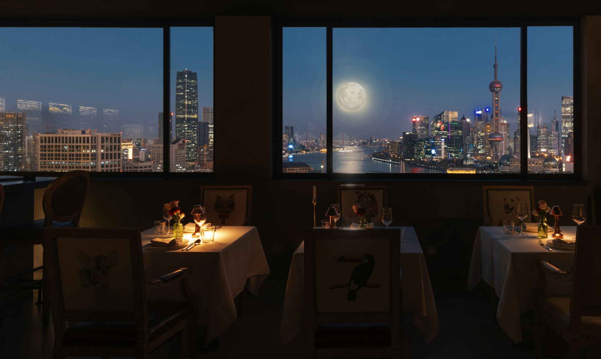 a restaurant with a view of the city at night