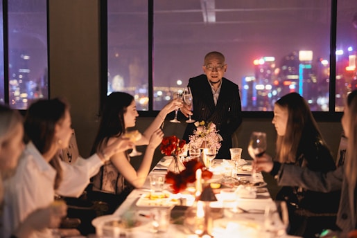 A joyful group enjoying a festive meal in a warmly decorated restaurant.