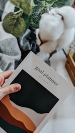 a person reading a book on a bed