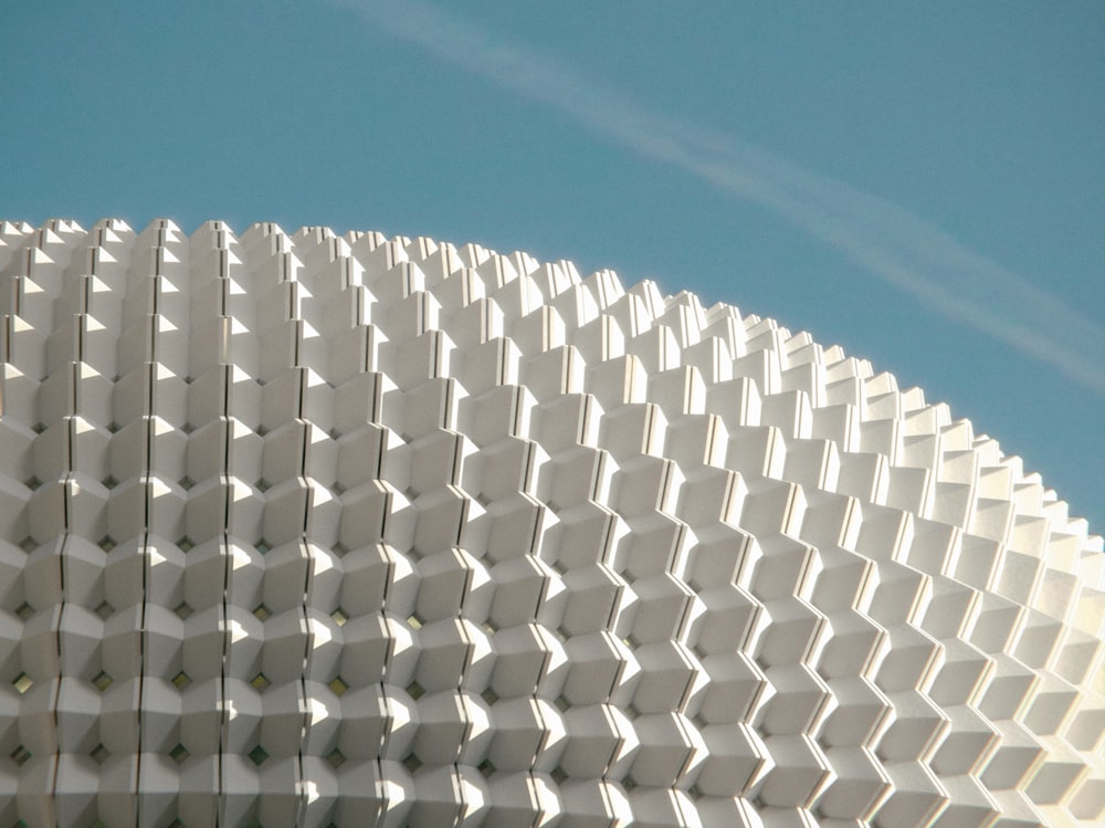 a close up of a white building with a blue sky in the background