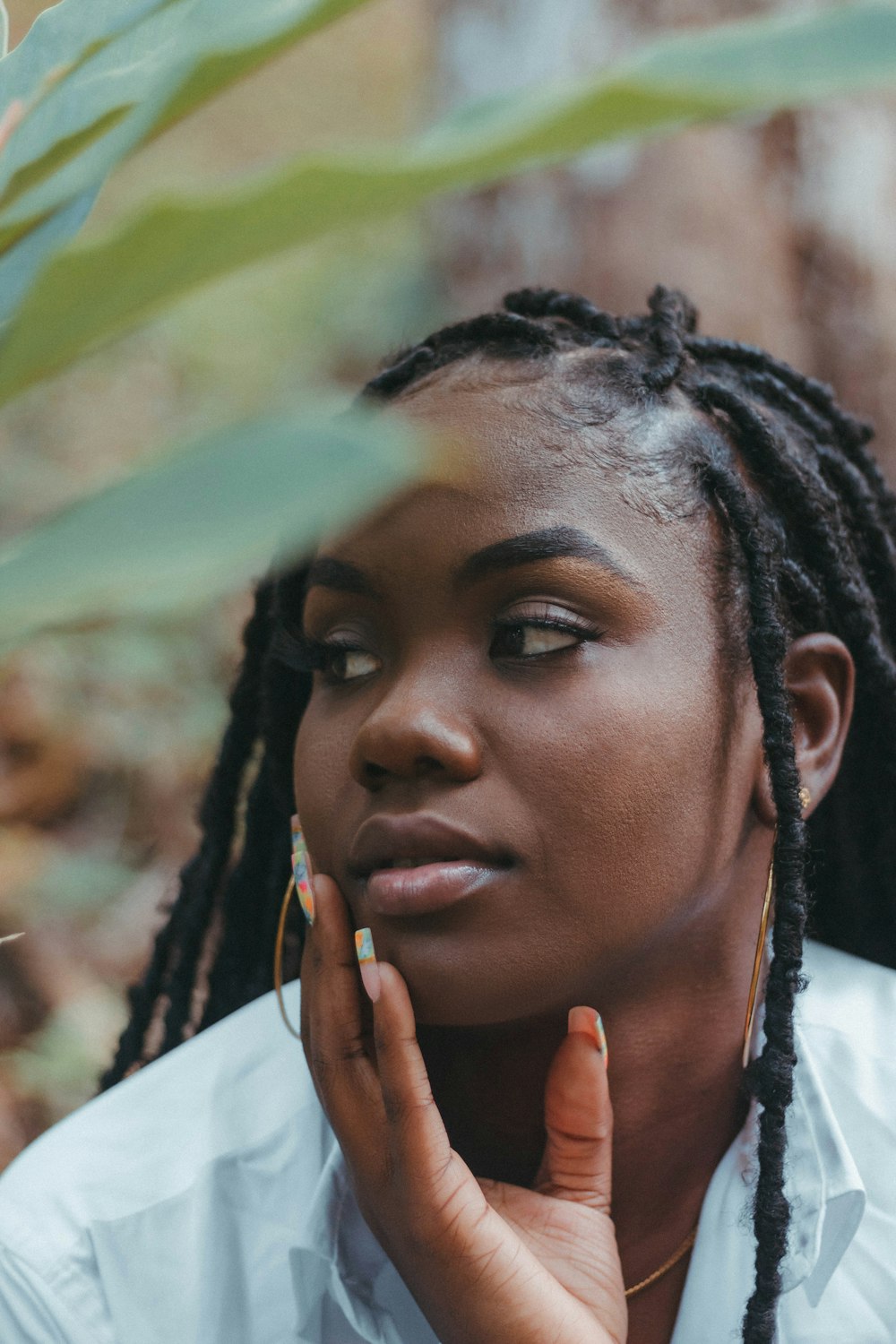 a woman with dreadlocks and a white shirt