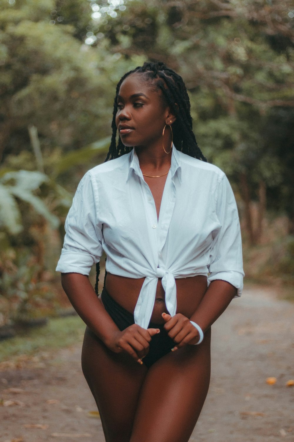 a woman wearing a white shirt and black shorts