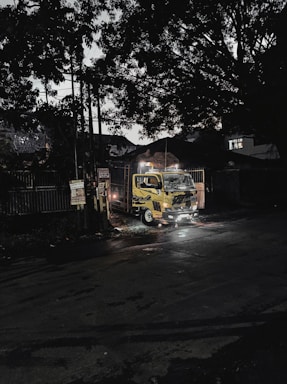 Tow truck parked on a city street at dusk.