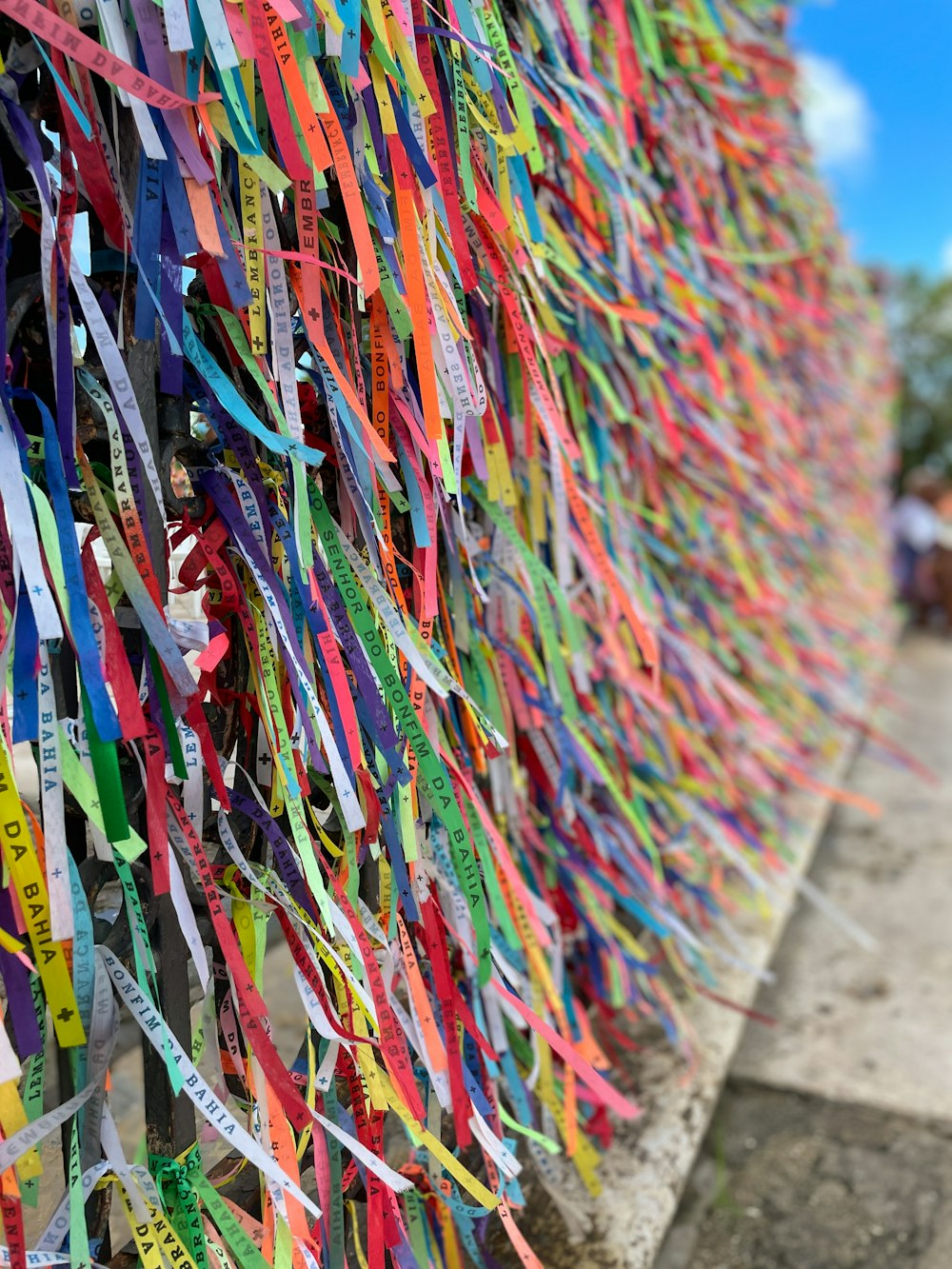 a wall covered in ribbons of different colors