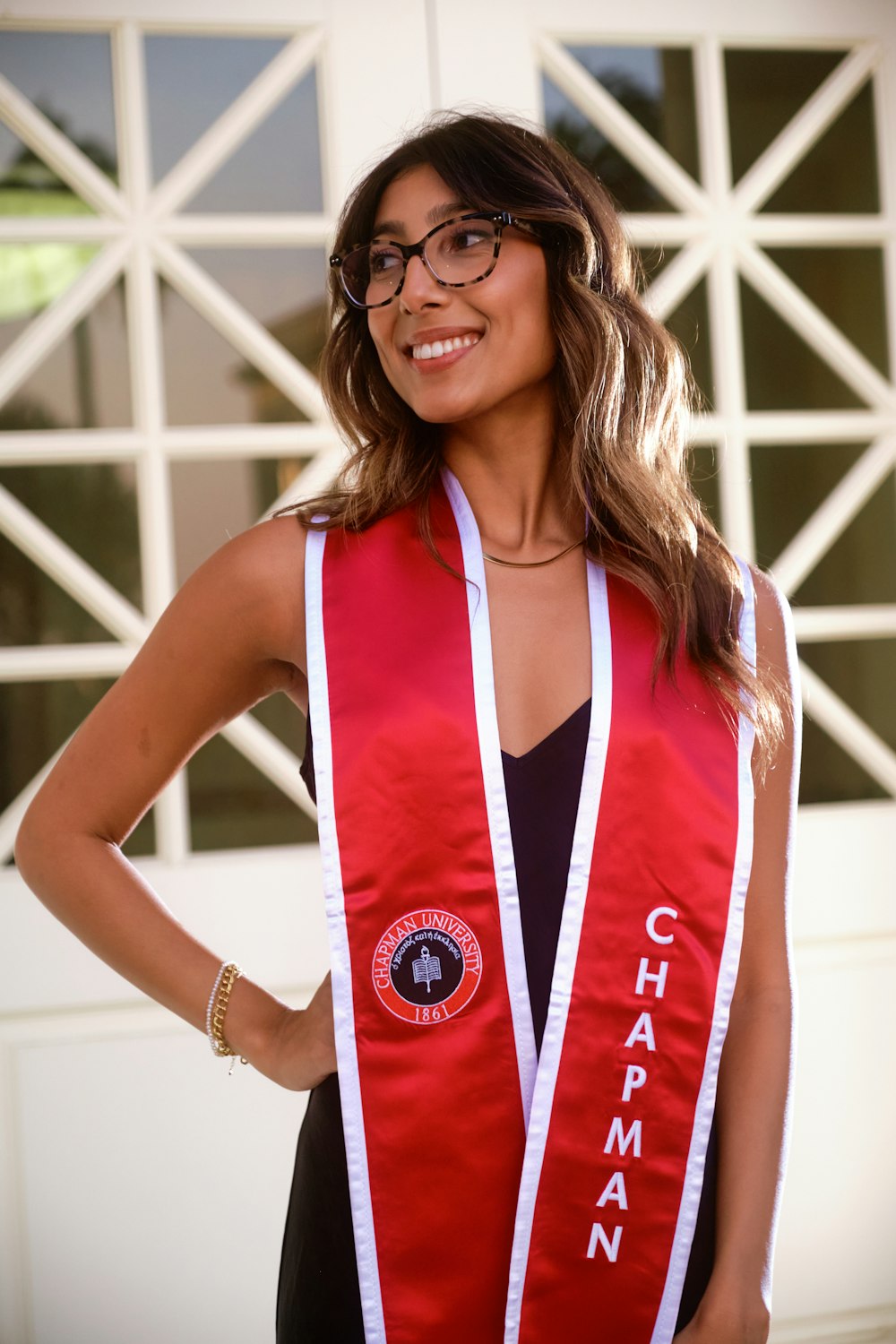 a woman wearing a red sash and glasses