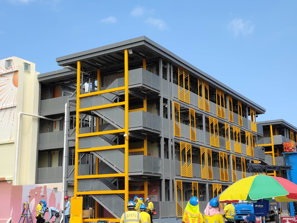 a group of people standing in front of a building under construction