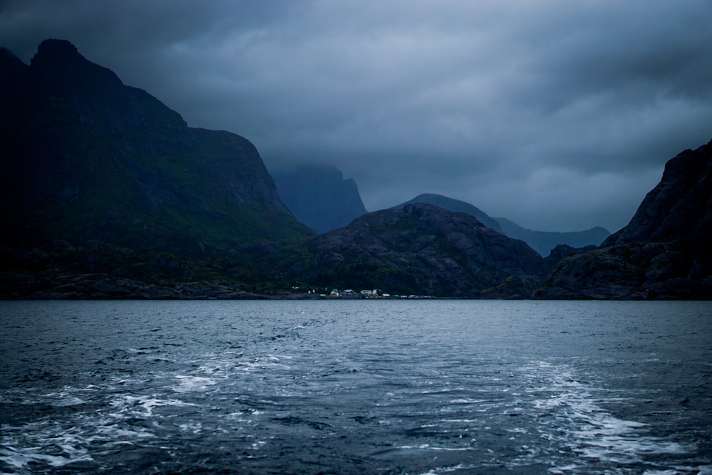 a body of water with mountains in the background