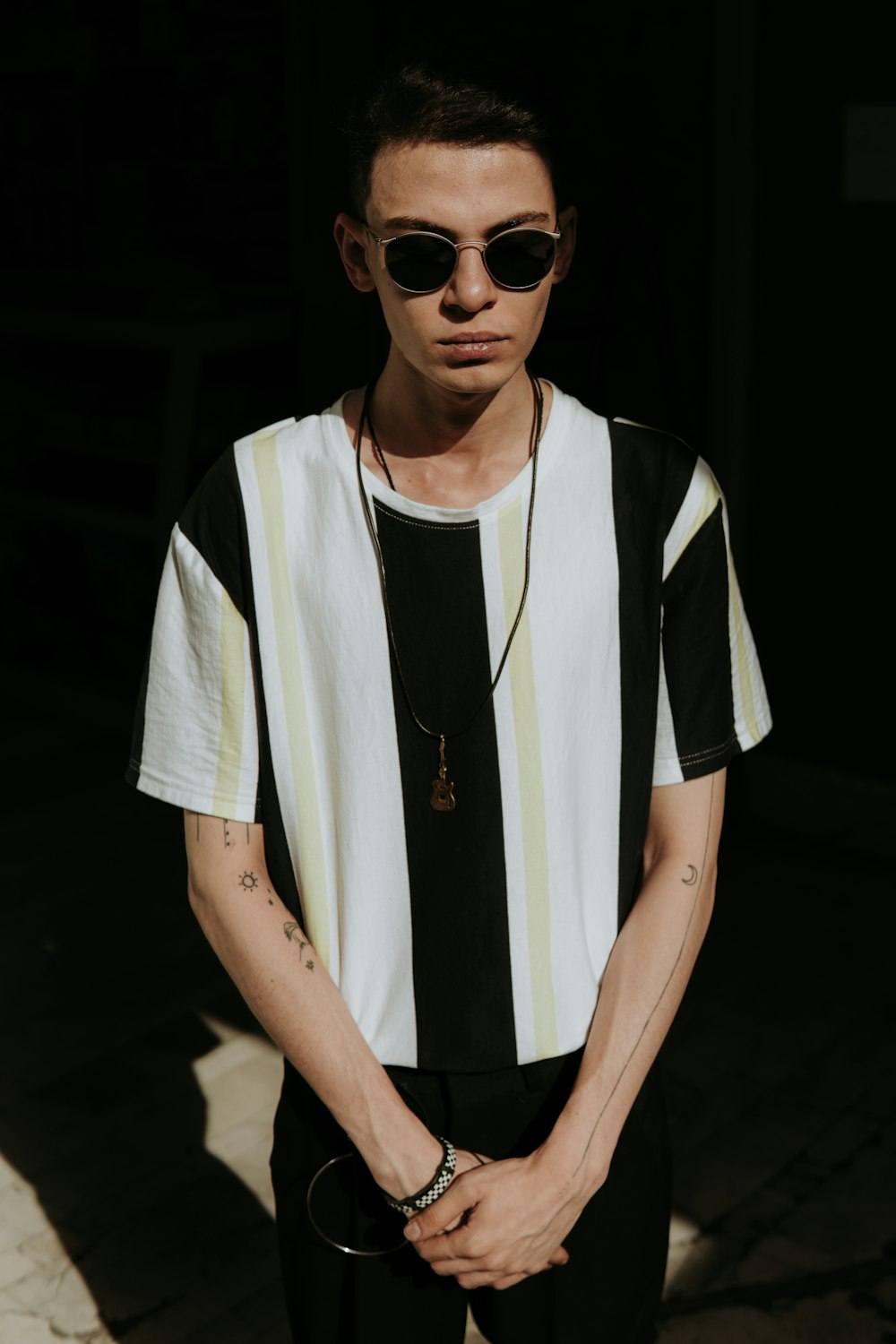 a man wearing sunglasses and a striped shirt