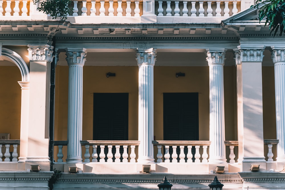 a building with columns and a clock on the front of it