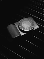 A hand holding a Vigila digital camera, highlighting its ergonomic grip and sleek finish.