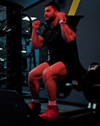 a man sitting on a bench in a gym