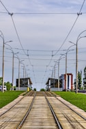 a train track running through a grassy area