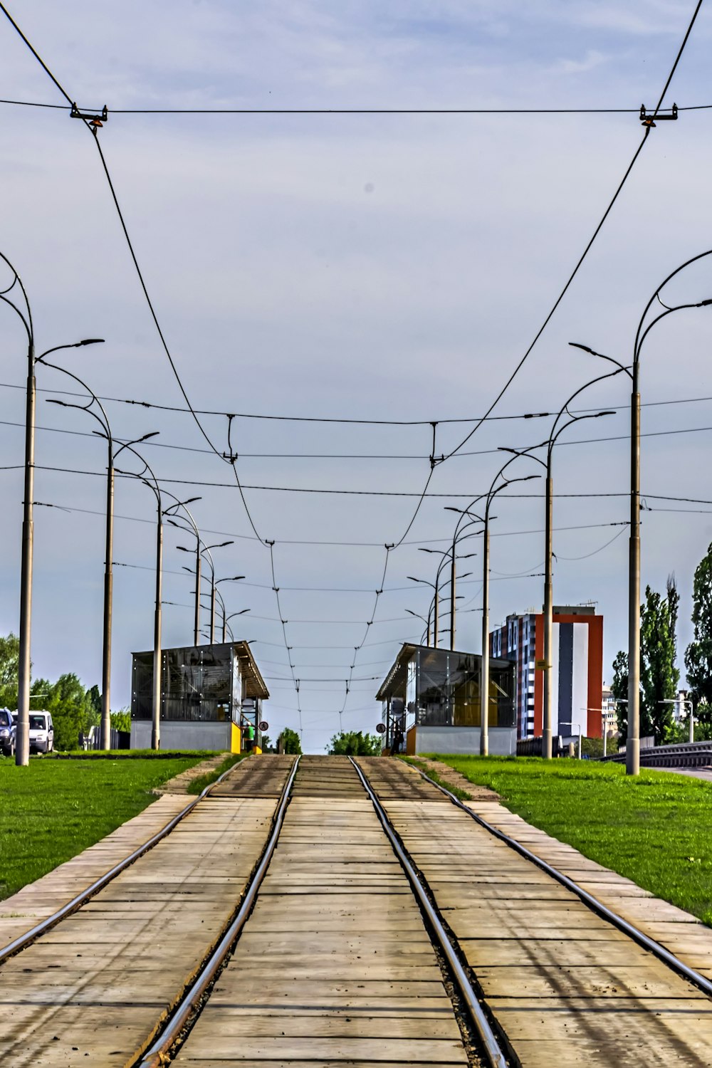 a train track running through a grassy area