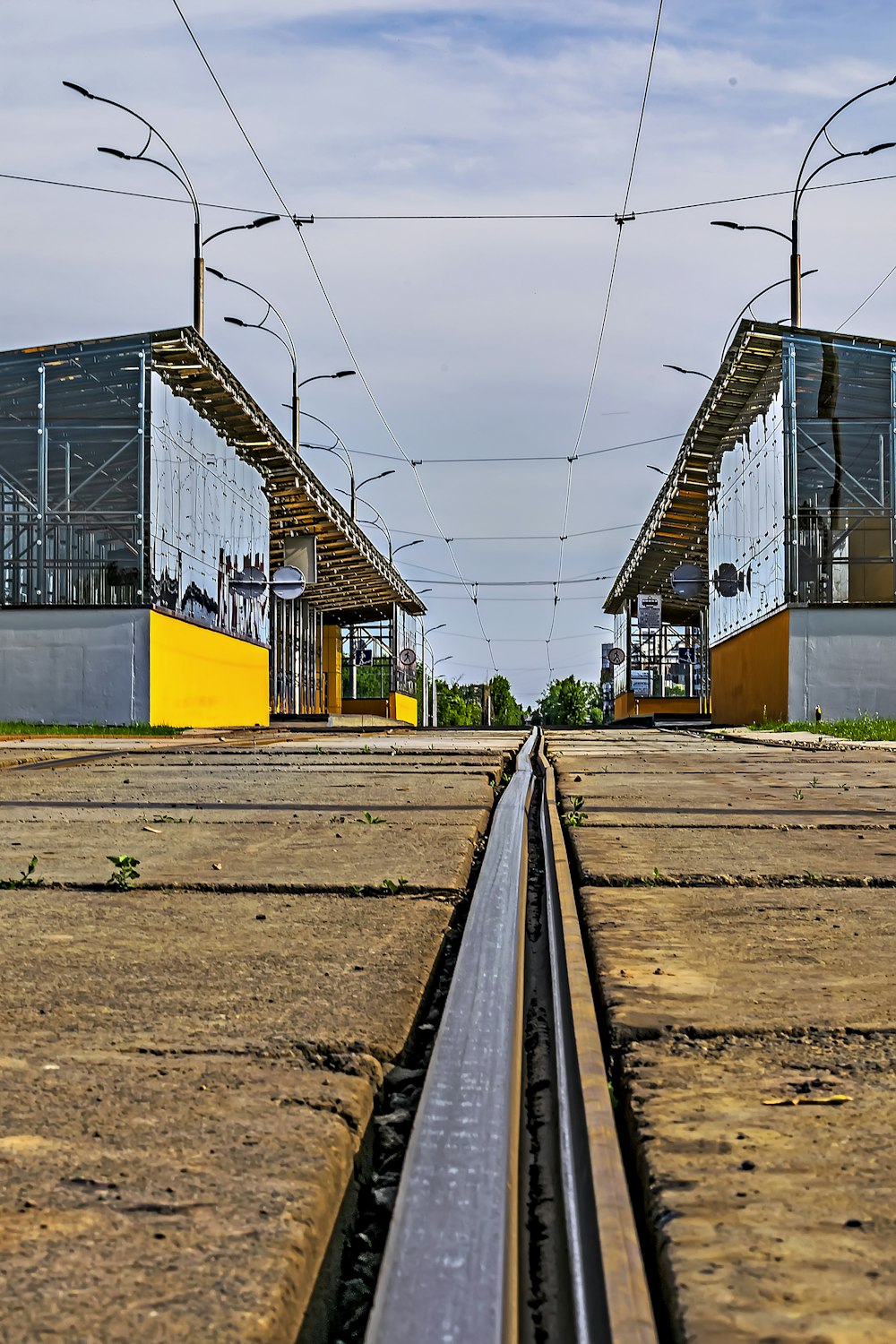 a train track with a yellow building in the background