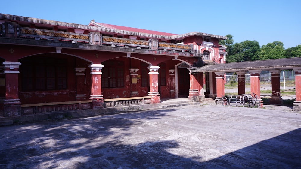 a red building with a lot of pillars and windows