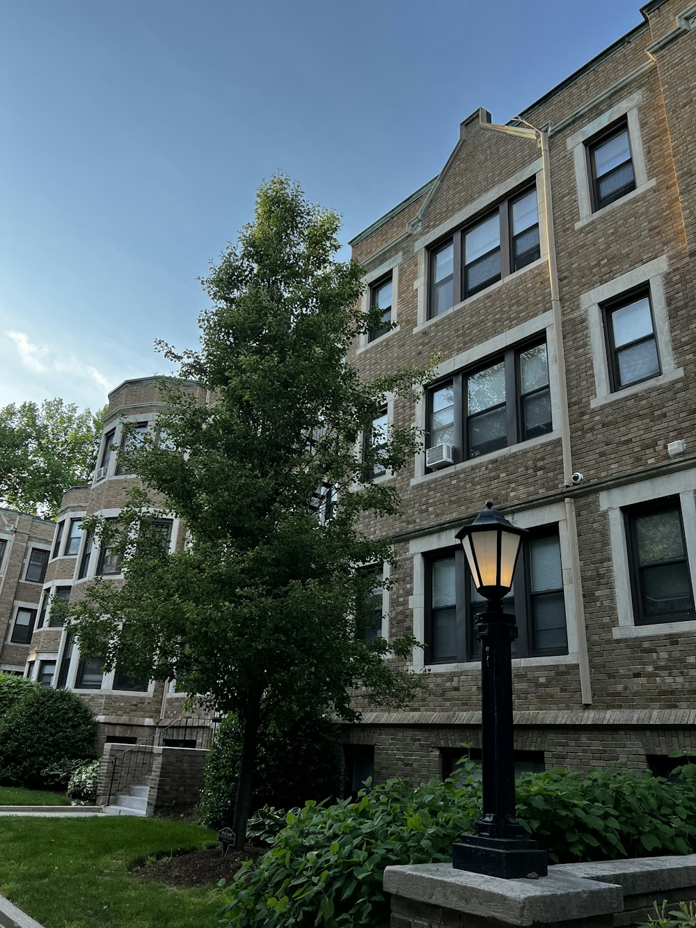 a lamp post in front of a brick building