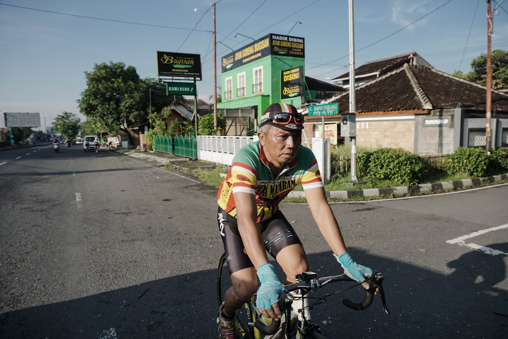 a man riding a bike down a street