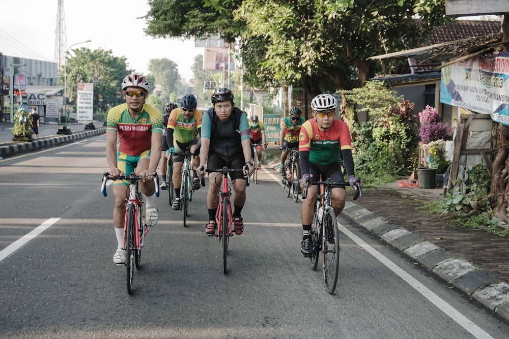 a group of people riding bikes down a street