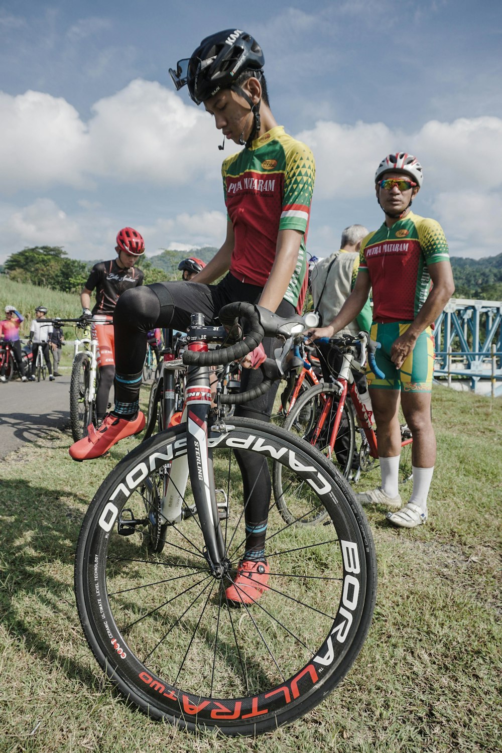 Un homme à vélo au sommet d’un champ verdoyant