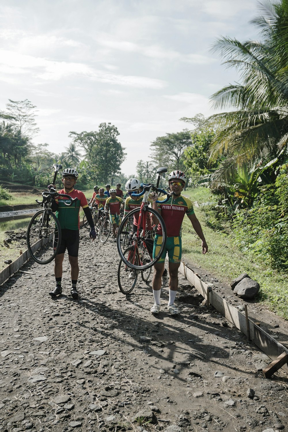 a group of men standing next to each other on a dirt road