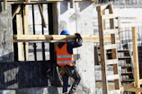 a construction worker is working on the side of a building