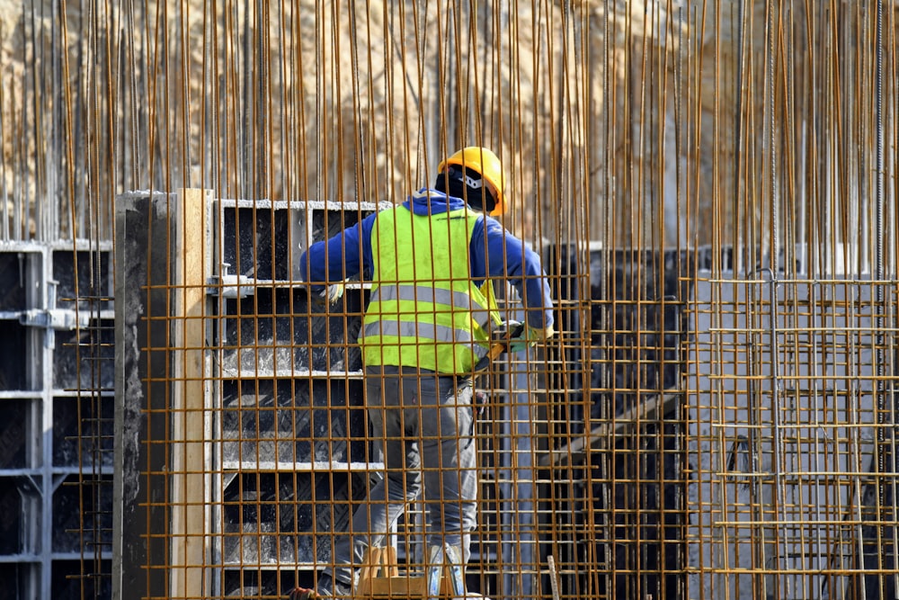 a man in a safety vest working on a construction site