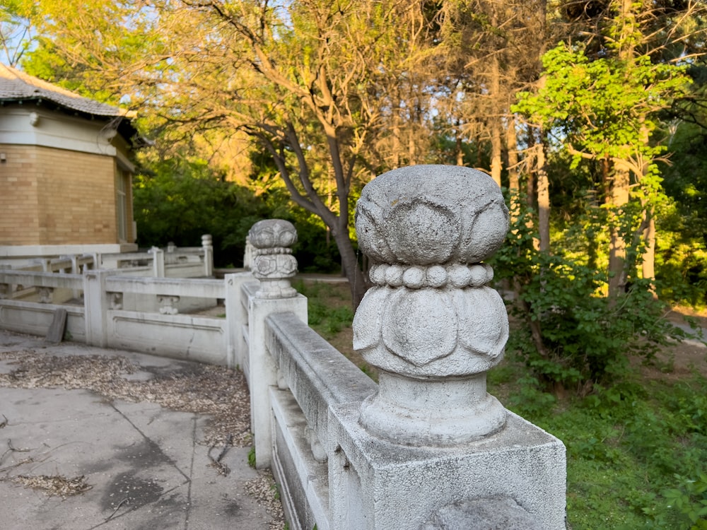 a stone fence with a building in the background