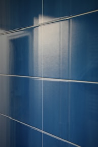 Close-up of glossy ceramic tiles arranged in a stylish kitchen backsplash.