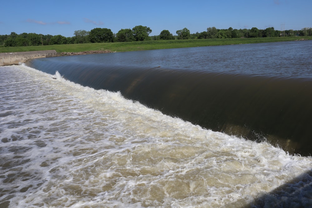 a man riding a surfboard on top of a river