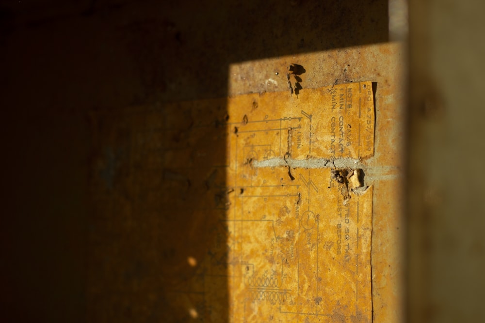 a yellow piece of paper sitting on top of a wall