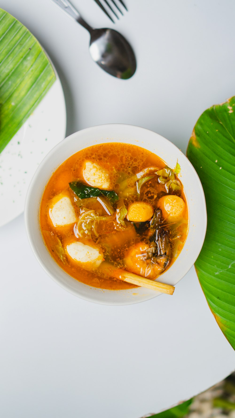 a bowl of soup on a white table