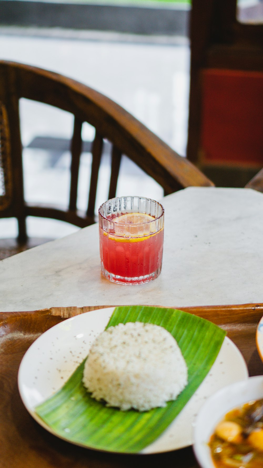 a plate of rice and a drink on a table