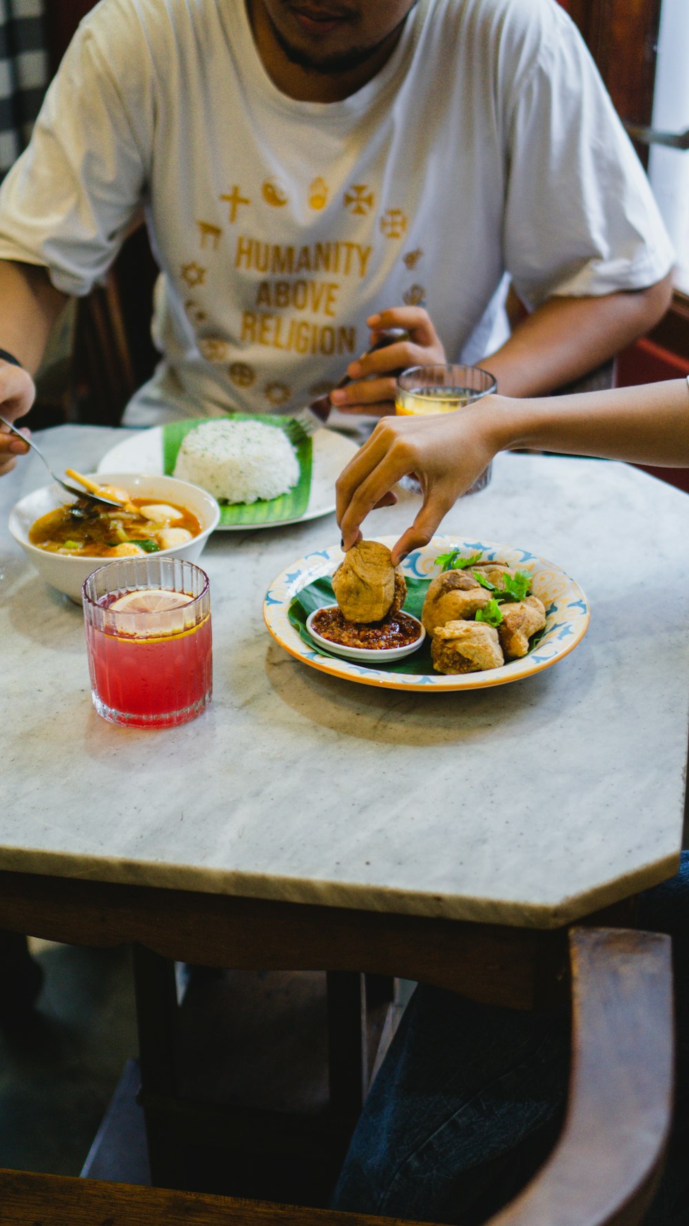 a man sitting at a table with a plate of food