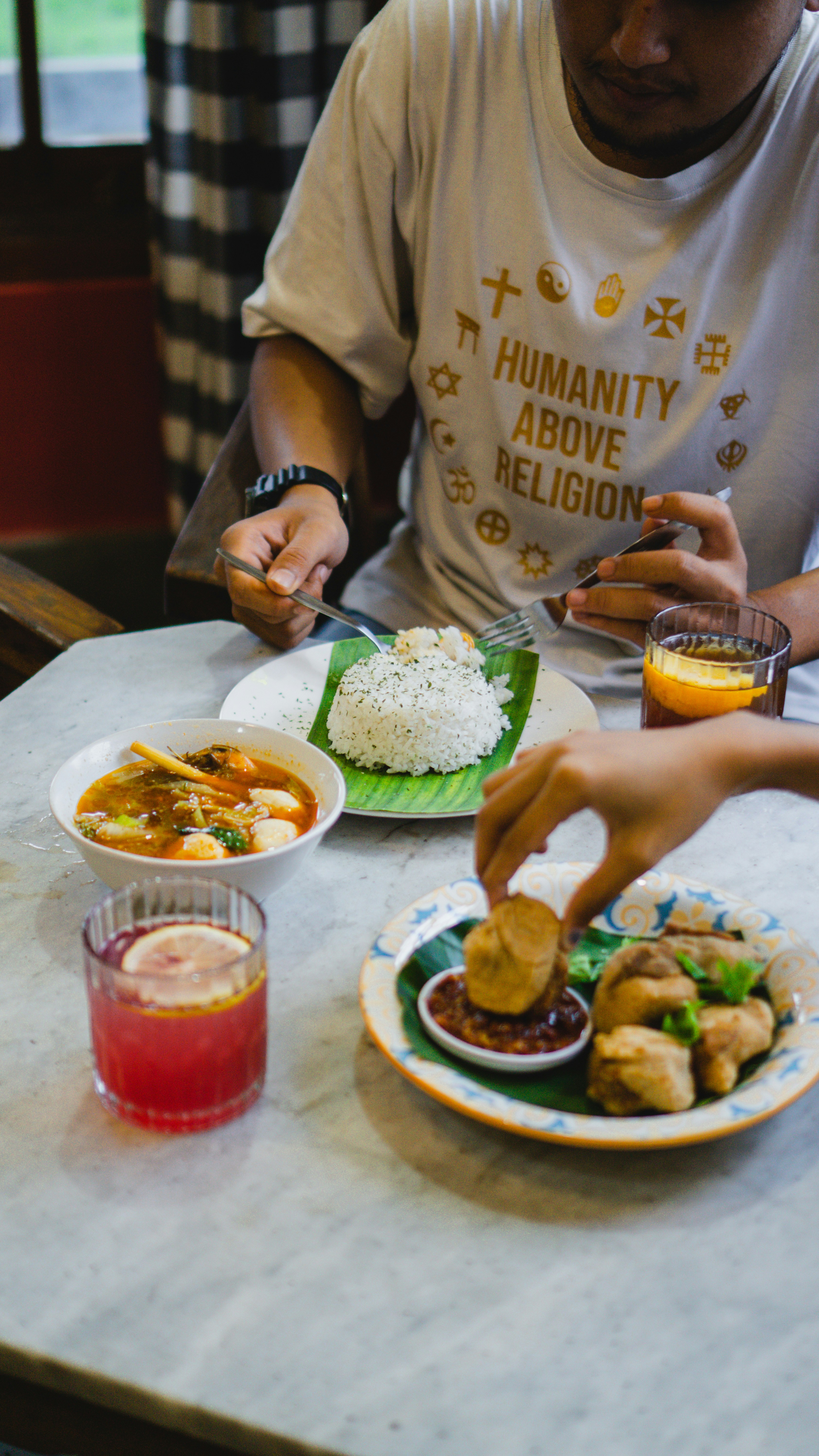 a man sitting at a table with a plate of food