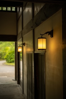 Classic lantern lighting casting a warm glow over a tailored millwork hallway.
