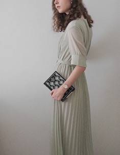 a woman in a long dress holding a book