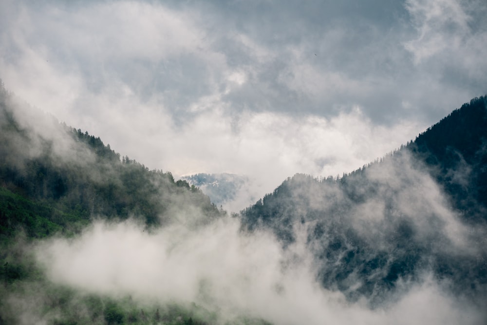 a mountain covered in fog and low lying clouds