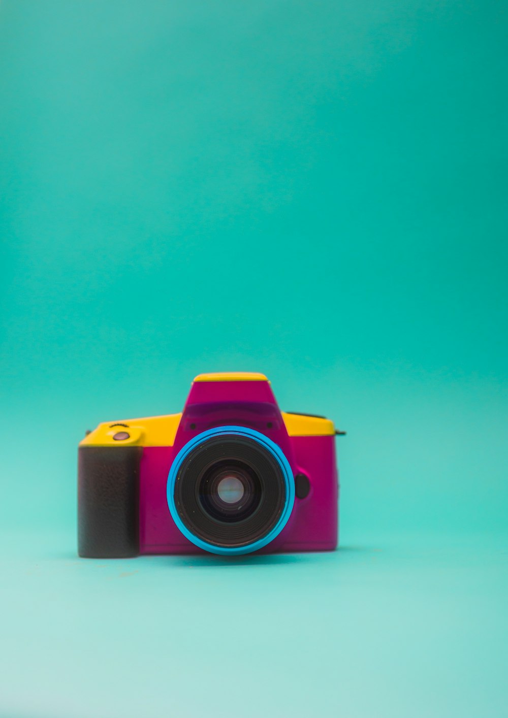 a camera sitting on top of a blue surface