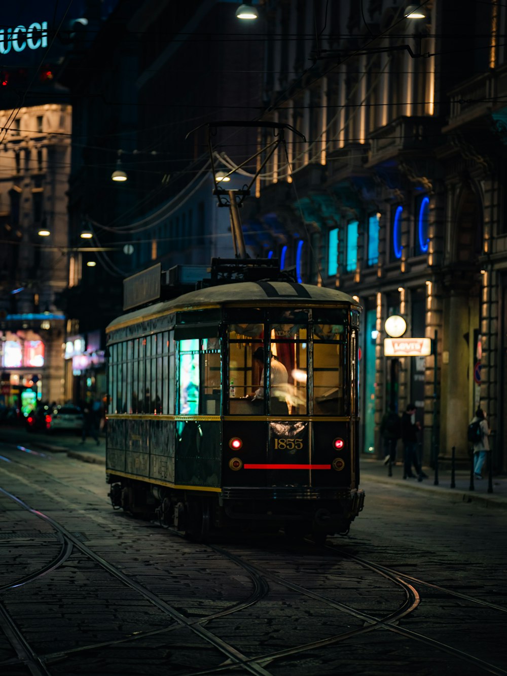 a trolley car on a city street at night