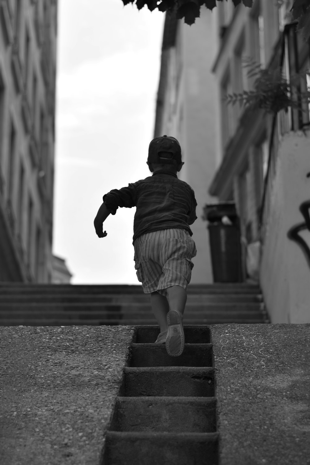 a little boy that is walking down some stairs