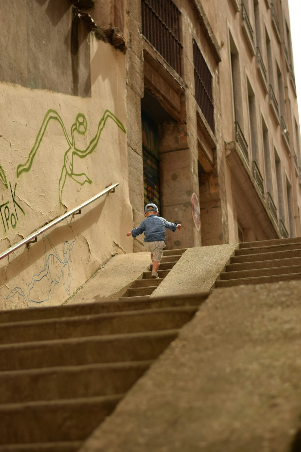 a young boy riding down a flight of stairs