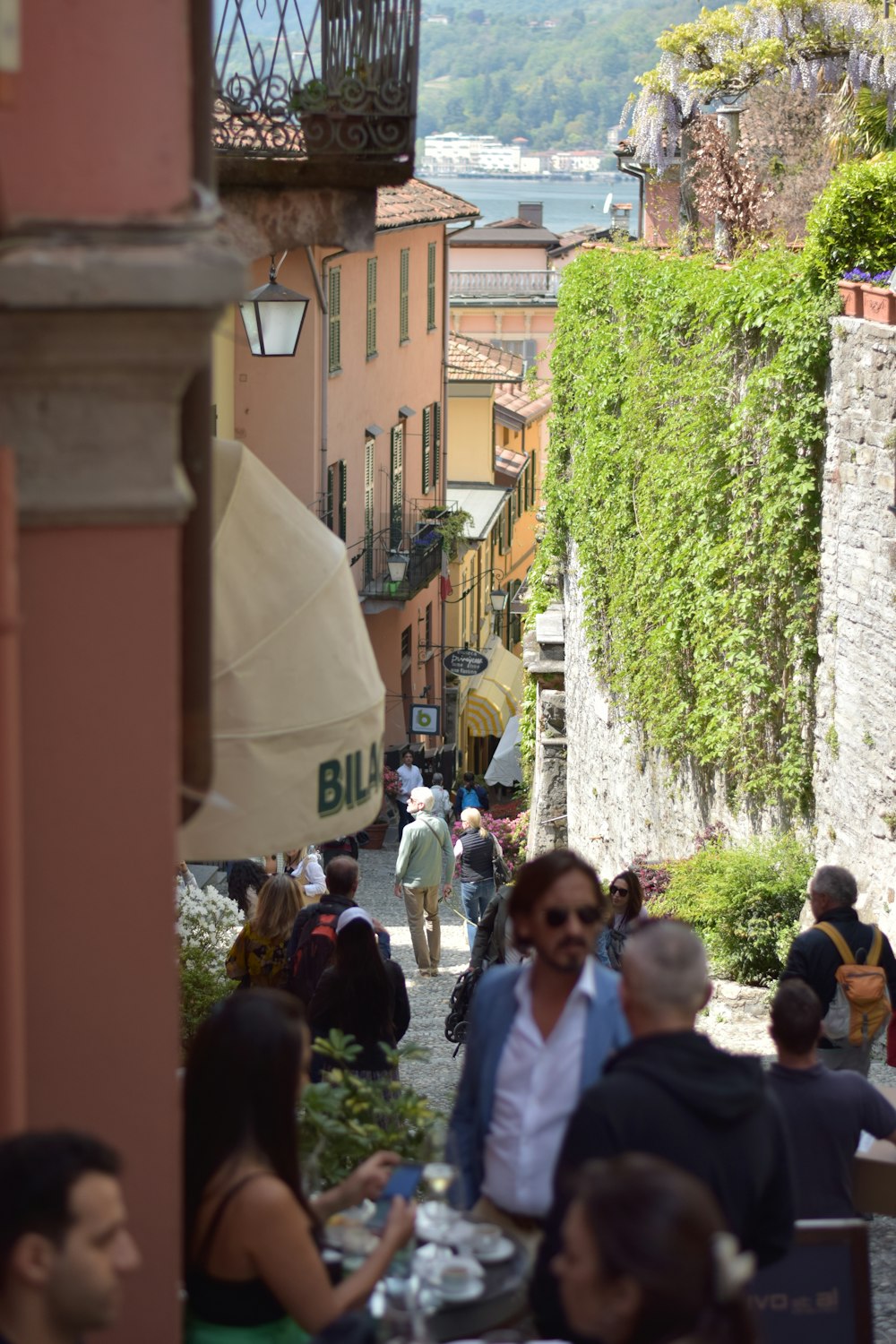 a group of people walking down a street next to buildings