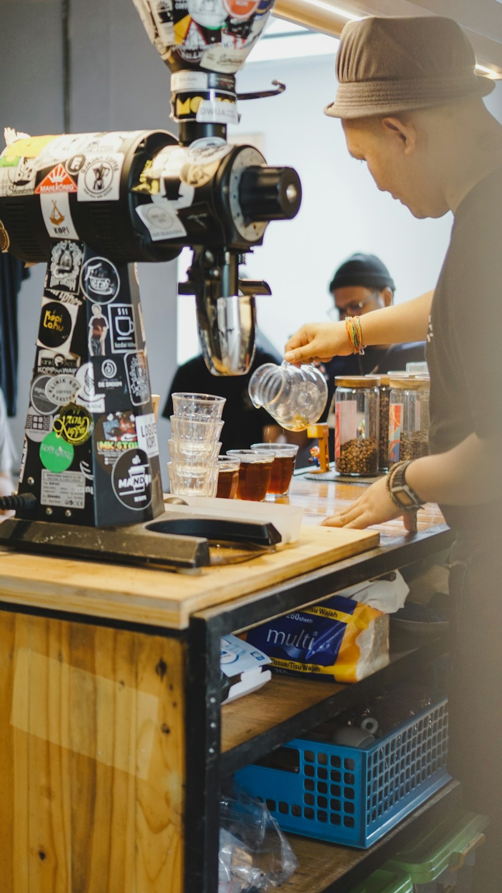 a man standing at a counter making a drink