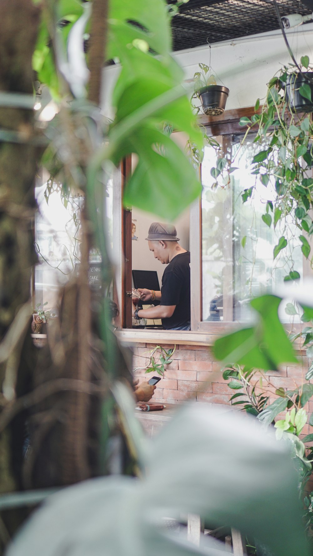 a man working on a laptop in a window