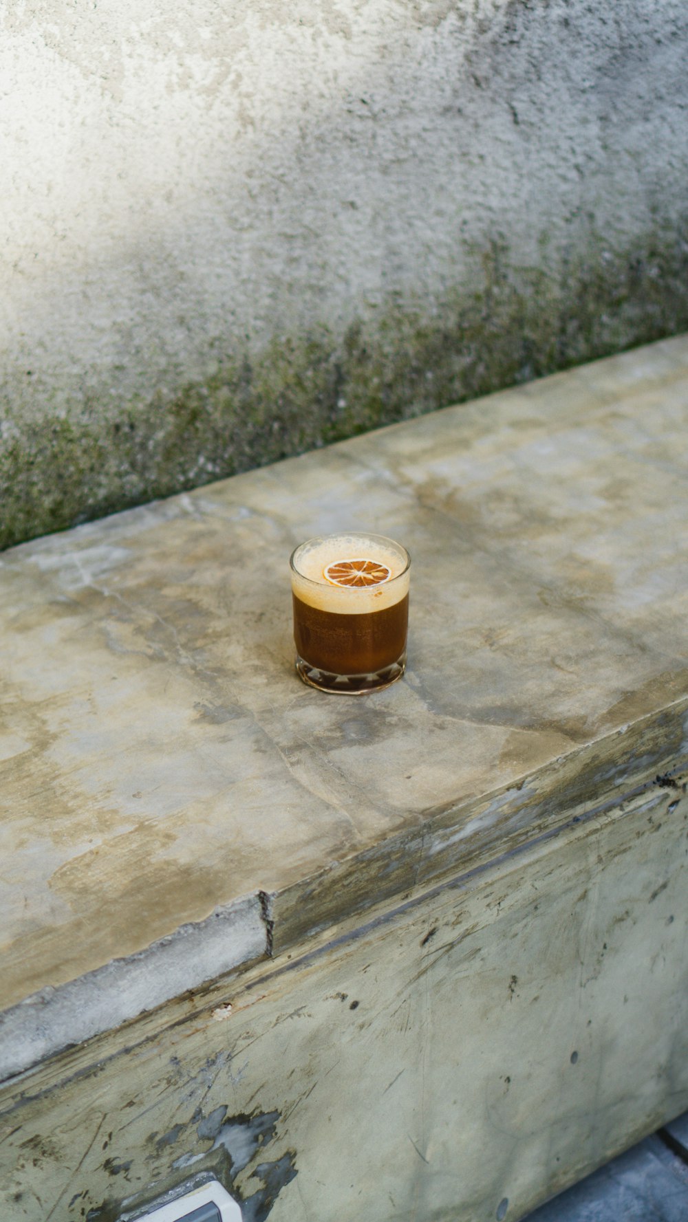 a cup of coffee sitting on top of a wooden table