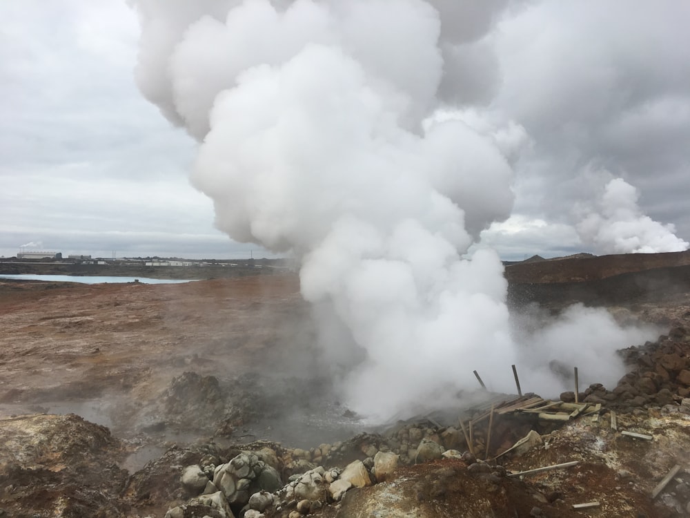 a large plume of steam rising out of the ground