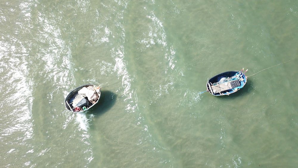 a couple of small boats floating on top of a body of water
